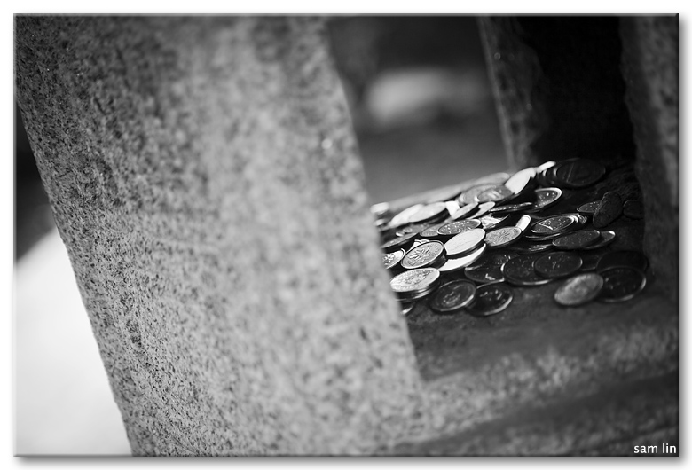 Coins inside Stone Lantern